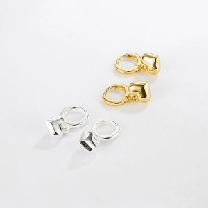 Minimalist 925 silver puffy heart earrings in gold and silver finishes on white background