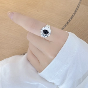 Vintage 925 sterling silver ring with oval black agate stone on light wood background