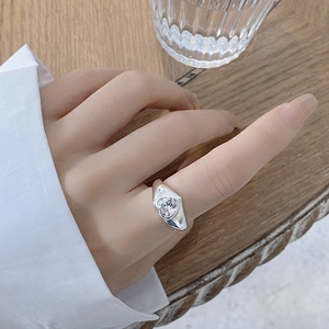 Close-up of 925 sterling silver ring with a large heart-shaped zircon on a finger