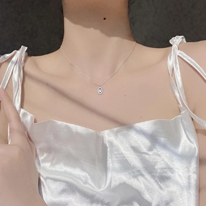 Detail of S925 silver oval pendant necklace with blue moonstone and pavé zircons on model
