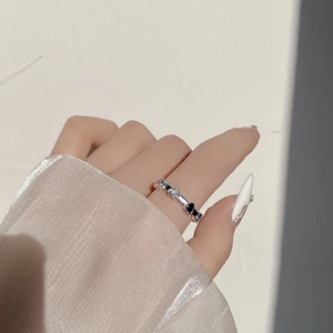 Detail of S925 silver ring featuring multi-colored heart-shaped zircon stones on finger