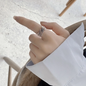 Macro shot of minimalist S925 sterling silver hollow geometric ring on female finger