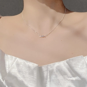 Macro shot of S925 sterling silver thorn pendant necklace on woman's collarbone