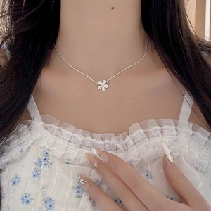 Elegant S925 sterling silver daisy flower pendant necklace shown on a model neck