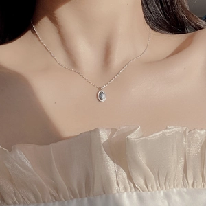 Minimalist S925 sterling silver oval bean necklace with dark gemstone on model