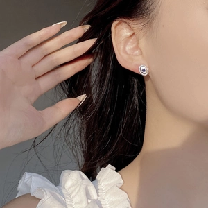 Detailed view of S925 silver oval stud earrings with blue sapphire and micro-set diamonds