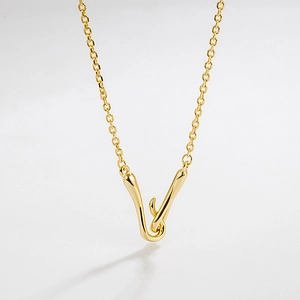 Macro view of gold S925 silver necklace with interlocking organic V-shaped pendant detail