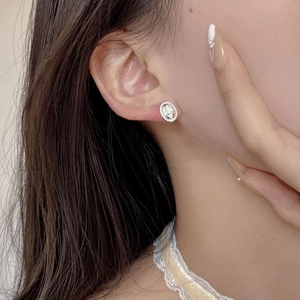 Close-up of S925 sterling silver oval stud earrings with marquise zircon inlay
