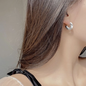 Minimalist S925 sterling silver C-shaped matte hoop earrings worn by a model