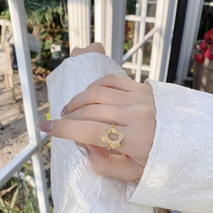 Macro view of 925 sterling silver gold ring with irregular hammered foil texture