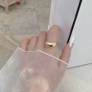 Bague haricot dorée minimaliste au fini poli brillant, portée pour un style moderne