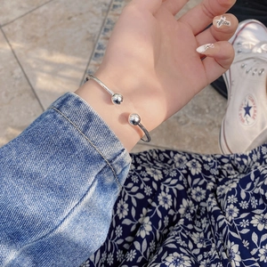 Minimalist 925 sterling silver open bangle featuring double beads on a woman wrist