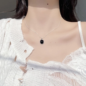 Minimalist 925 sterling silver snake chain necklace with oval black onyx pendant on neck
