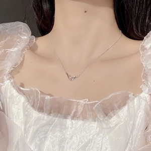 Close-up of S925 sterling silver interlocking pendant on a delicate chain necklace