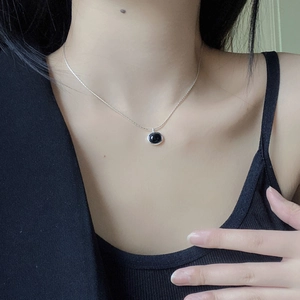 Elegant S925 sterling silver necklace with oval black onyx pendant worn on collarbone