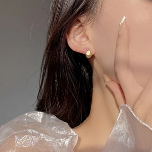 S925 silver irregular pebble stud earrings with matte gold sandblasted finish on model