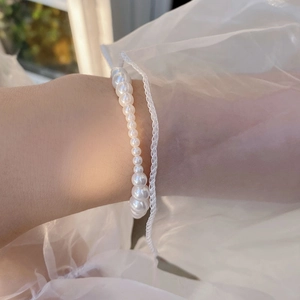 Close-up of elegant S925 silver pearl bracelet with gradient size pearls on a wrist