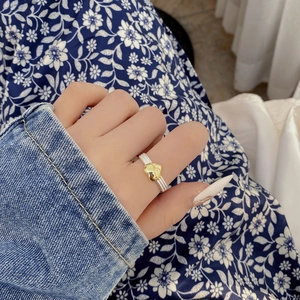 925 silver adjustable twist ring with a gold heart pendant shown on a model hand