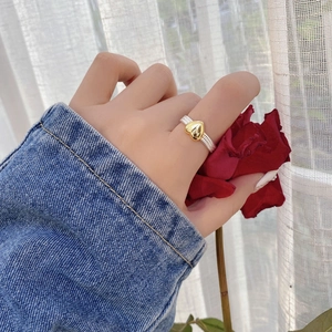 Adjustable S925 silver braided ring featuring a contrasting golden heart ornament