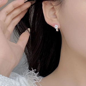 Close-up of S925 sterling silver hoop earring with brilliant six-claw zircon stone