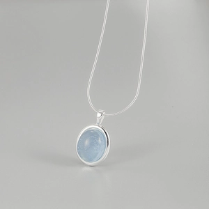 Minimalist S925 sterling silver necklace with oval aquamarine pendant on grey background