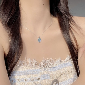S925 sterling silver necklace featuring an oval natural aquamarine pendant on a model