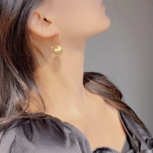 Minimalist S925 sterling silver brushed golden ball earrings shown on a model