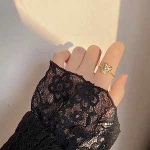 Detail of vintage gold heart ring with pleated metal texture and heart-shaped zircon