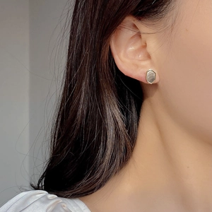 Elegant geometric hexagonal S925 silver stud earrings with natural shell on ear