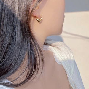 Minimalist gold heart hoop earrings for women shown on model for elegant style