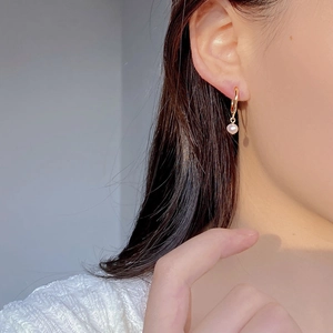 Orecchini a cerchio a C dorati retrò francese con pendente in perla d'acqua dolce su modella