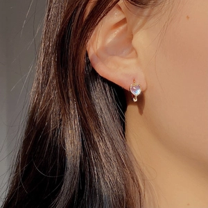 Elegant S925 silver heart moonstone earrings with warm gold plating on a model