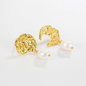 Detailed close-up of gold lava texture earrings with baroque pearls on white background