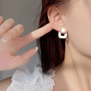 Detail of 925 sterling silver geometric square earrings with matte brushed texture finish
