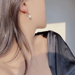 Elegant 925 sterling silver heart earrings with white pearls shown on a model