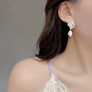 Close-up of S925 silver lava earrings with teardrop baroque pearls on model's ear
