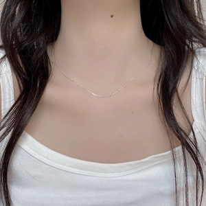 Close-up of minimalist S925 sterling silver thin bamboo chain necklace on model neck