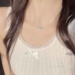 Minimalist S925 sterling silver necklace with three beads shown on a model neck