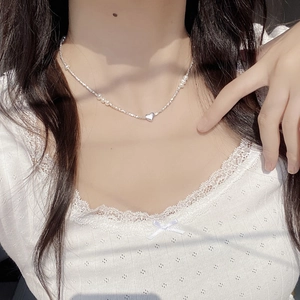 Elegant S925 sterling silver heart necklace with white natural pearls worn by model
