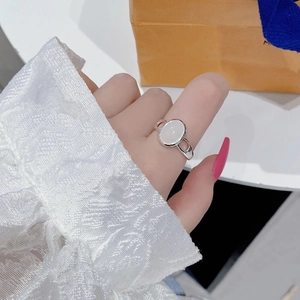 Vintage S925 sterling silver ring with oval opal stone shown on hand in soft lighting