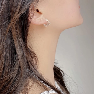 Close-up of minimalist S925 sterling silver square hoop earrings with vertical texture