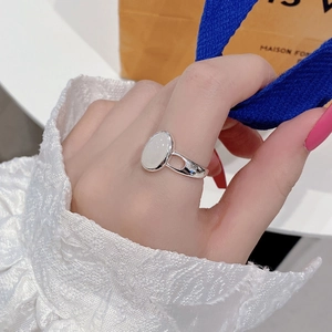 Detailed macro view of S925 sterling silver cat eye stone ring with hollow geometric band