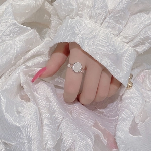 S925 sterling silver open ring with oval opal stone shown on hand with lace background
