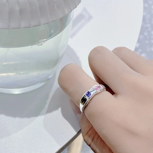 Close-up of S925 sterling silver geometric ring featuring green, purple and pink zircon gems
