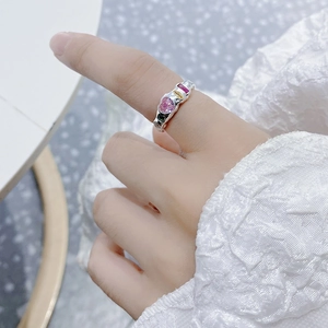 Macro view of S925 silver ring with irregular lava texture and multicolor gemstones