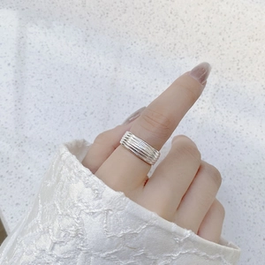 Close-up of S925 sterling silver multi-layer overlapping ring on finger with lace sleeve