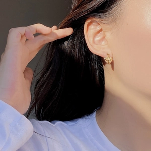 Detailed view of S925 sterling silver golden heart stud earrings with textured finish