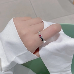 Detail of S925 silver ring featuring a red heart stone and love script engraving