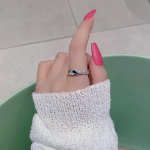 S925 sterling silver ring with blue rectangular gemstone and white stones on finger