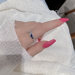 Detail of S925 silver ring with blue rectangular gemstone and accent diamonds on hand